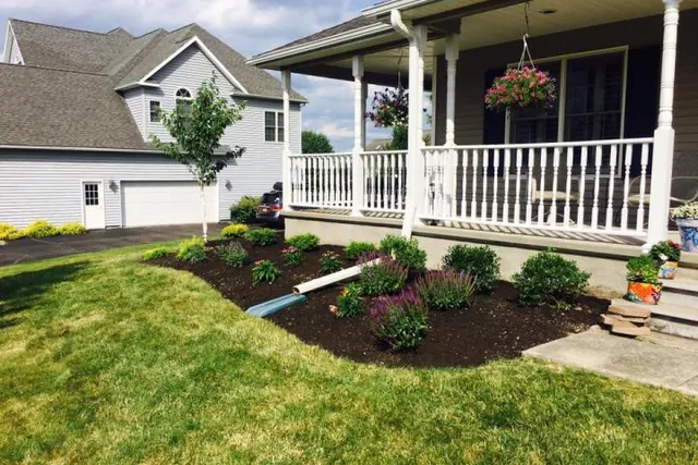 Front entry with a new bed, shrubs and stone edging.